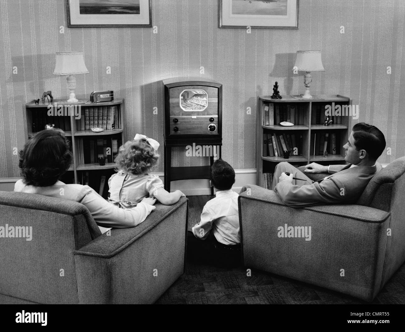 1940s 1950s FAMILY WATCHING TV IN LIVING ROOM Stock Photo Royalty