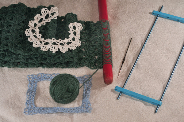 My grandmother's tools, including two thread lace projects she did and the L'Oreal highlighting tool she used as a size 7 crochet hook, which has become my favorite hook for threadwork.
