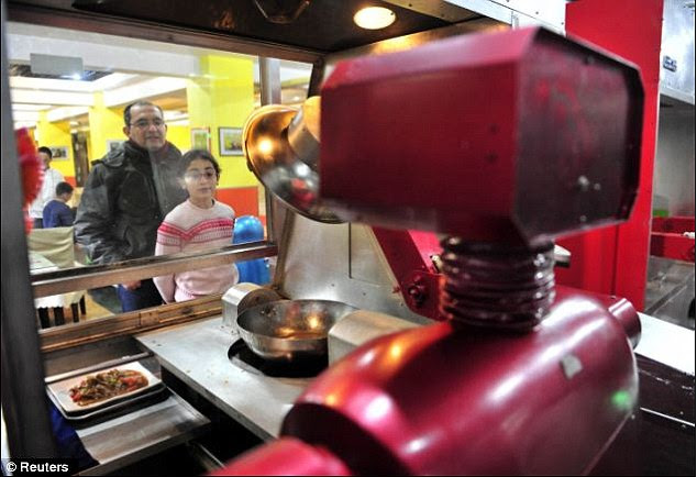 Mechanical master chef: Customers at the restaurant watch a robot prepare their food