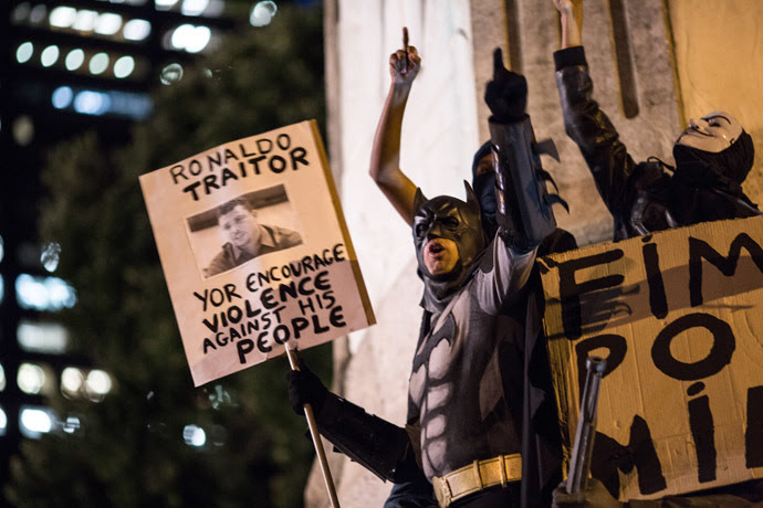 A man fancy-dressed as American comic hero Batman shouts slogans during a protest by anarchist group Black Bloc against the FIFA World Cup in Rio de Janeiro, Brazil, on May 30, 2014 (AFP Photo/YASUYOSHI CHIBA)