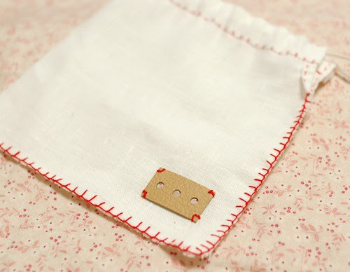 Linen pouch with a leather tag