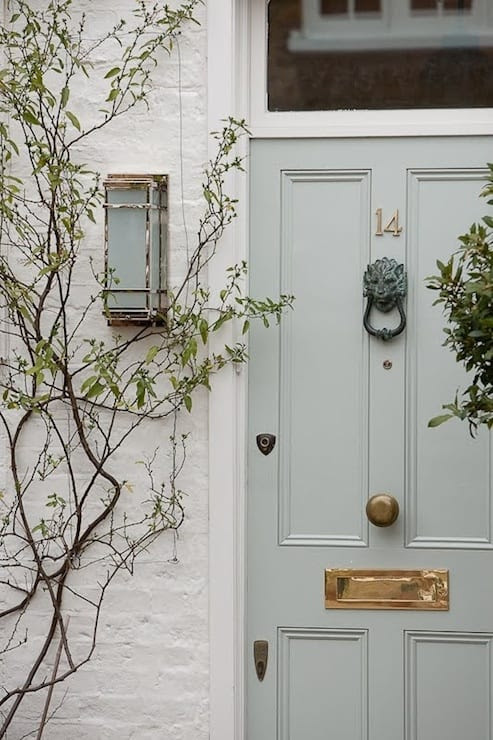 Mixing vintage and new front door hardware with a brass mailbox.