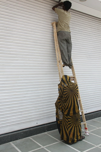 beneath the ladder of success a man climbs lies the forgotten woman by firoze shakir photographerno1