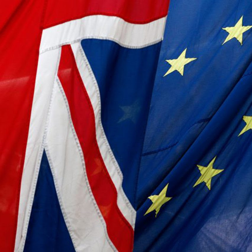European Union and UK flags fly together.