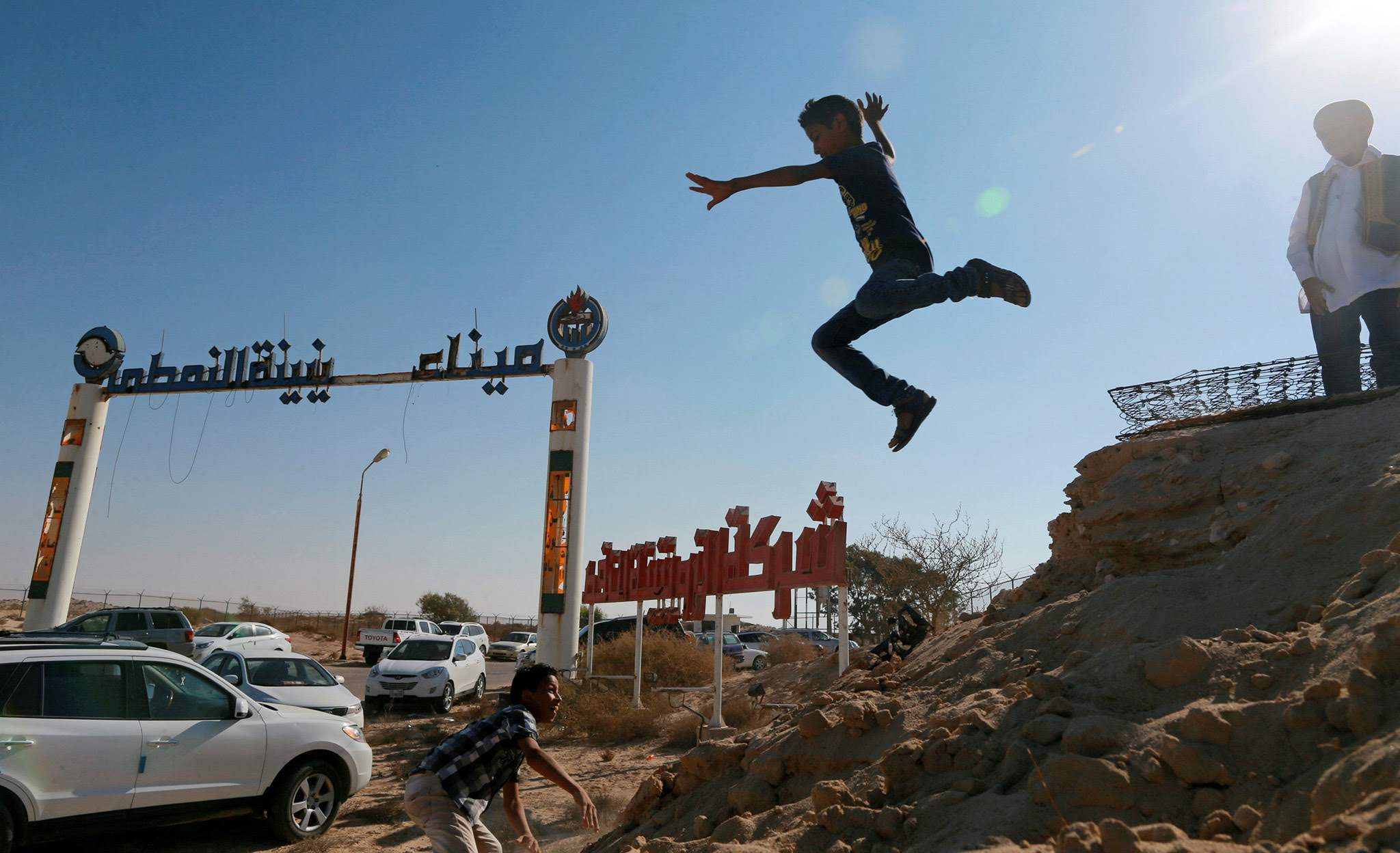 Boys play next to the gates of the Zueitina oil terminal, west of Benghazi, Libya September 14, 2016. Picture taken September 14, 2016. REUTERS/Esam Omran Al-Fetori