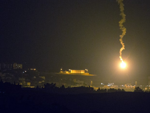 Foto da fronteira de Israel com a Faixa de Gaza mostra ataque aéreo iluminando o território palestino nesta segunda-feira (7) (Foto: Jack Guez/AFP)