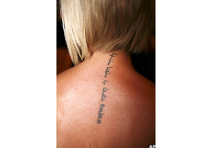 The Hebrew script on Victoria Beckham's upper back reads: 'I am my beloved's 