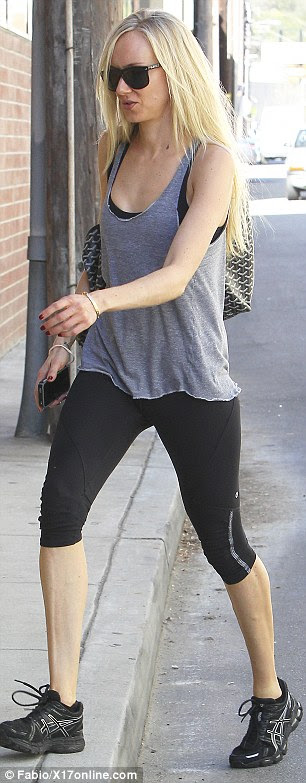 Bare-faced: Make-up free, Kimberly had her long blonde locks out in a straight style and shielded her eyes with some black-rimmed sunglasses 
