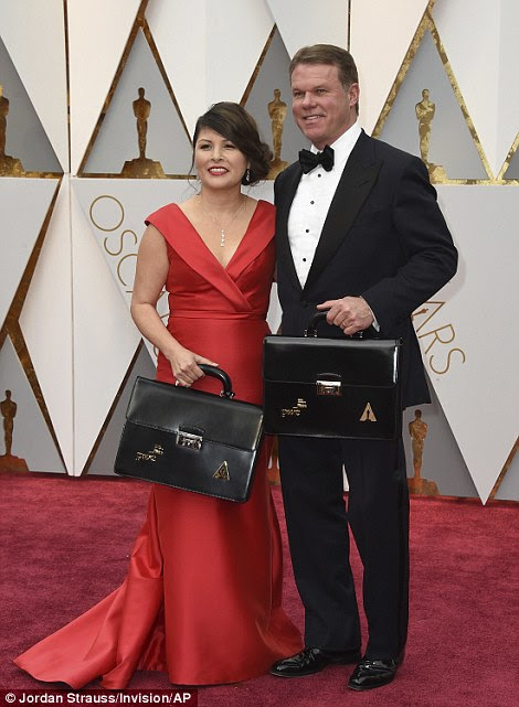Accountancy firm PricewaterhouseCoopers's Brian Cullinan and Martha Ruiz were in charge of this year's top-secret Academy Awards results. They're posed together above with the two sets of envelopes, which are carried in briefcases