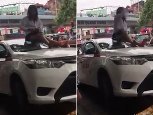 Nữ tài xế taxi mặc váy leo nóc xe “ăn vạ” CSGT