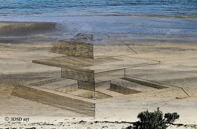 Beaten by the tide: The top of the trio's 'deconstructed pyramid' is washed away by the sea