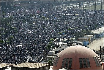 People gather in Tahrir, or Liberation, Square in Cairo, Egypt, Tuesday, Feb. 1, 2011. Security officials say authorities have shut down all roads and public transportation to Cairo, where tens of thousands of people are converging to demand the ouster of Egyptian President Hosni Mubarak after nearly 30 years in power. Part of the Egyptian Museum is seen in the foreground. (AP Photo/Lefteris Pitarakis)