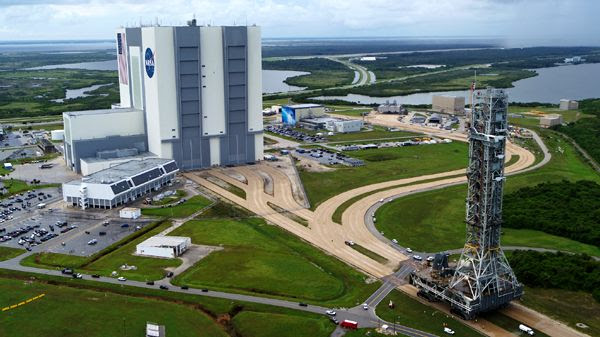 The SLS Mobile Launcher rolls past the Vehicle Assembly Building (VAB) as it makes its way to LC-39B at NASA's Kennedy Space Center in Florida...on August 30, 2018.