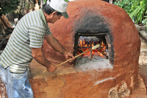 Roasting a chipa caburé, a type of cake, in a tatakua, or traditional oven.