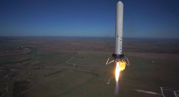 As the unmanned Hexacopter hovers nearby, the Grasshopper test vehicle begins to descend after reaching an altitude of 744 meters (2,441 feet) above McGregor, Texas, on October 7, 2013.