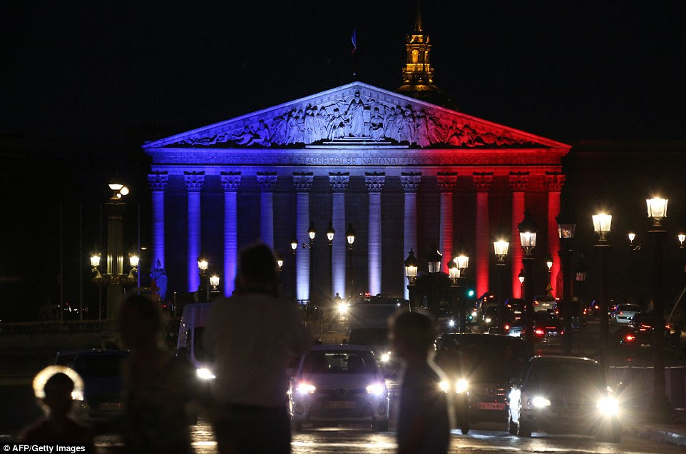 Da Assembleia Nacional Palais Bourbon em Paris iluminado nas cores da bandeira francesa em homenagem às vítimas do ataque na cidade de Normandy de Saint-Etienne-du-Rouvray