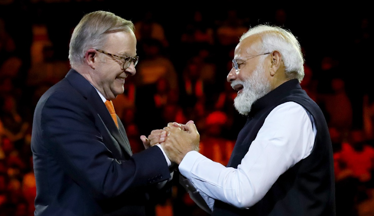 India's Prime Minister Narendra Modi (R) and Australia's Prime Minister Anthony Albanese shake hands while attending an Indian cultural event on May 23 2023 at the Qudos Bank Arena in Sydney, Australia. Picture: LIDA MAREE WILLIAMS/GETTY IMAGES