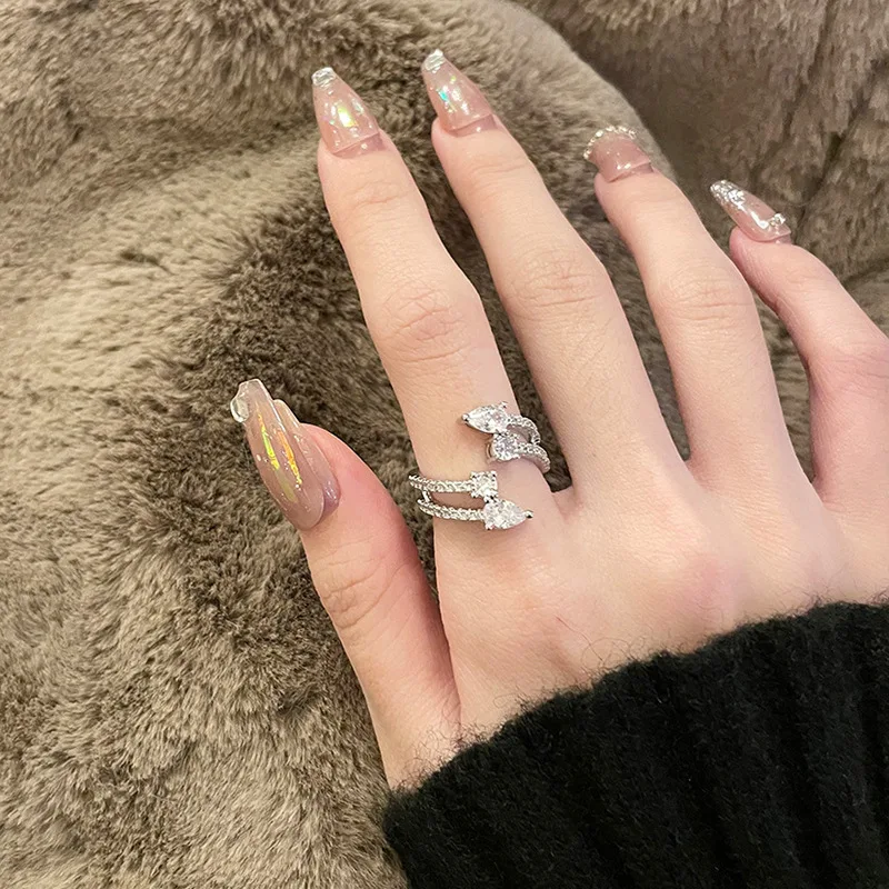 Bague ouverte double couche Cold Wind avec gouttes d'eau en zircon, un bijou élégant et intemporel. Parfait pour ajouter une touche de glamour à votre look.