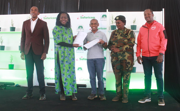 Kiambu Governor Kimani Wamatangi, Environment and Forestry CS Sopian Tuya, Safaricom CEO Peter Ndegwa, Deputy CCF Beatrice Mbula abd Absa Interim CEO Yusuf Omar display signed agreement documents during the marking of the edition off climate action agreement and signing at Kinale forest on April 4, 2023