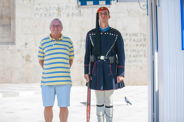 A visitor poses with an Evzones guard at the Tomb of the Unknown Soldier in Athens. 