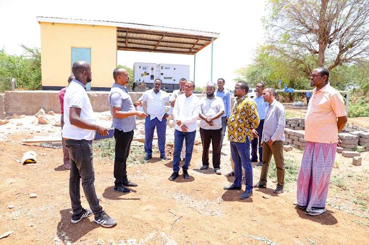 Garissa Deputy Governor Abdi Dagane with county and Gawasco officials in Bula Tawakal during a fact-finding mission on two major water projects in Garissa town.