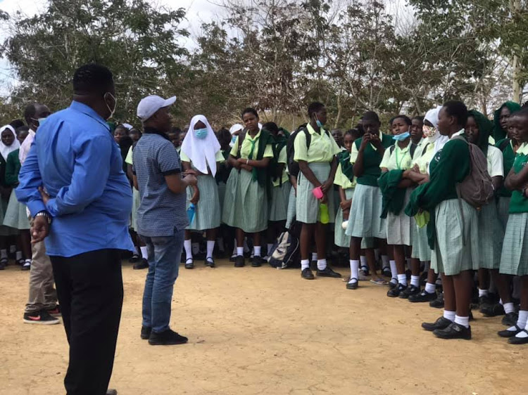 Ganze MP Teddy Mwambire addressing Ganze girls' high school students before the school was closed. Looking on is Ganze Sub county education officer Rashid Mjimba on Sunday morning