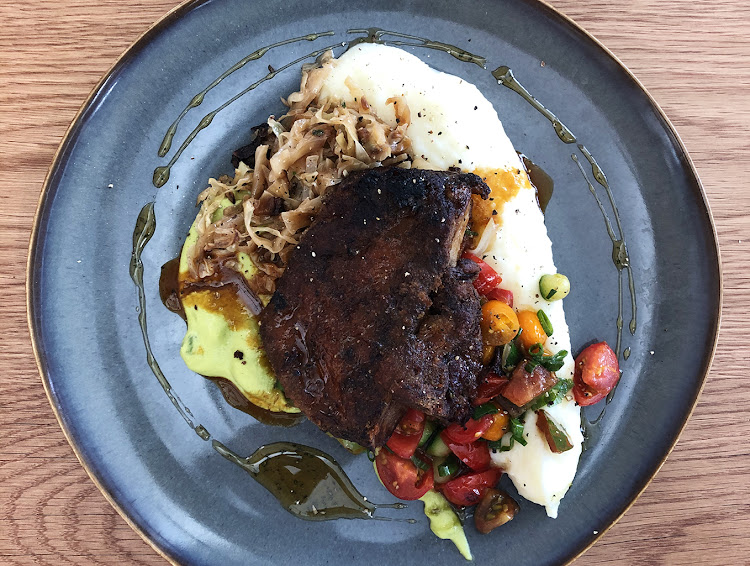 Lamb Shoulder served with pea puree, potato mash, grilled cabbage, zucchini and minted honey.