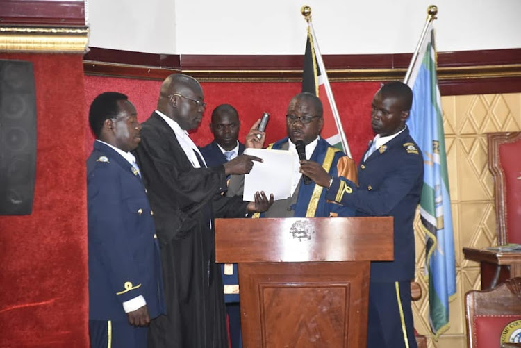 Kisumu county assembly clerk Owen Ojuok is sworn in at the assembly.