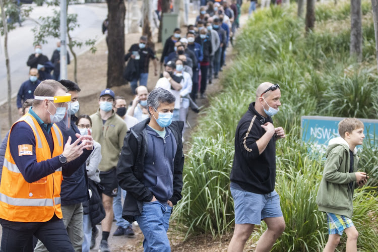 Long queues of people are seen at the New South Wales Covid-19 vaccination centre in Homebush on July 1 2021 in Sydney, Australia. Much of Australia is in lockdown or subject to some form of restriction as community cases of the delta variant continue to be recorded around the country. Picture: JENNY EVANS/GETTY IMAGES