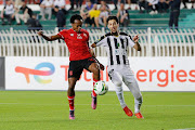 Percy Tau of Al Ahly is challenged by Hocine Laribi of ES Setif in the Caf Champions League semifinal second leg match at the July 5 1962 Stadium in Algiers, Algeria on May 14 2022.