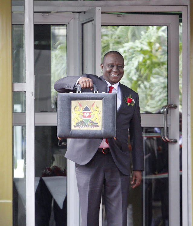 Treasury CS Henry Rotich displays the budget before heading to parliament