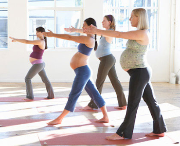 preganant women stretching in gym studio