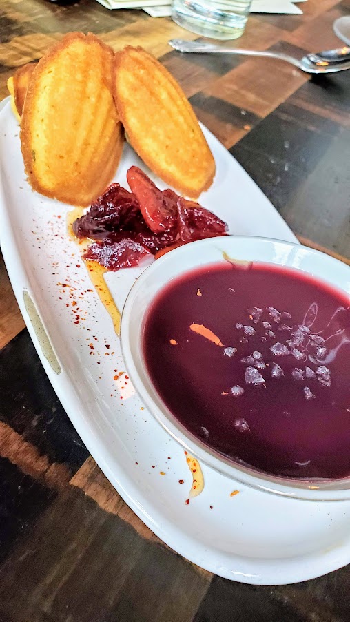 Duck Fat Madeleines, Port Poached Plums, Piment d’ Espelette Honey available at dinner and happy hour at Normandie PDX