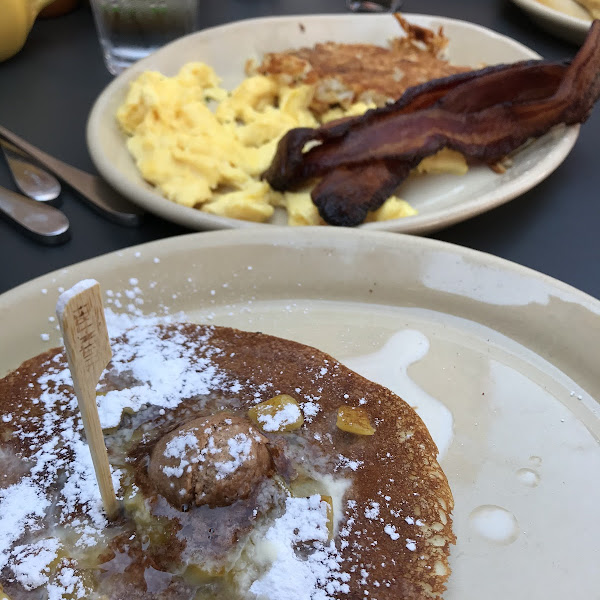 Pineapple upside down pancake, hash browns, bacon and scrambled eggs.