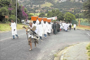 LONG WALK: Members of Shembe Church walk  behind 
      
       Prophet Phakama Shembe in Bassonia, Johannesburg, during the prayers for a peaceful Easter weekend
      
      . 
       PHOTO: MOHAU MOFOKENG