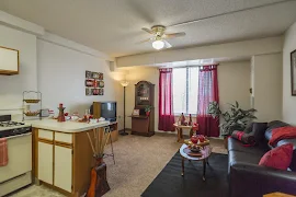 Open concept living and dining room with window and blind, ceiling fan and light