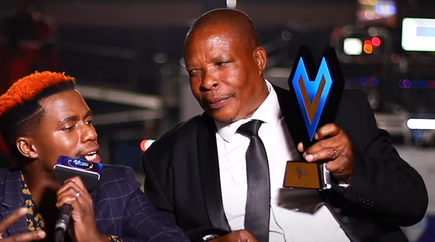 Ntate Phalane with presenter Smash Afrika during a post award interview.