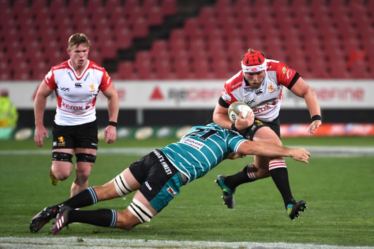 Corne Fourie of of the Xerox Golden Lions tackled by Jonathan Janse van Rensburg of the Tafel Lager Griquas during the Currie Cup match between Xerox Golden Lions XV and Tafel Lager Griquas at Emirates Airline Park on August 24, 2018 in Johannesburg, South Africa.