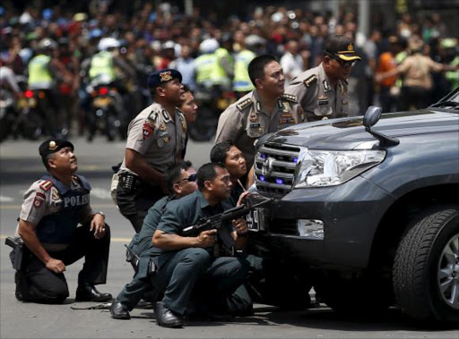 Police officers react near the site of a blast in Jakarta, Indonesia, January 14, 2016. REUTERS/Darren Whiteside