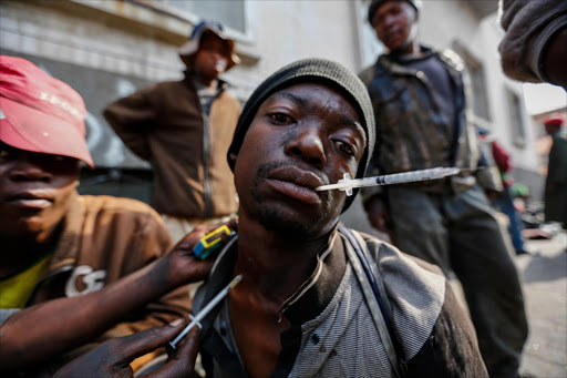 A man gets injected with the drug nyaope on Goud Street in Johannesburg on 17 May 2016. The street has become a haven for drug dealers and addicts alike.