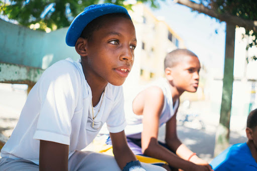 DR-Local-Kid-on-Bleachers.jpg - Work with local literacy advocates in Puerto Plata, the Dominican Republic.