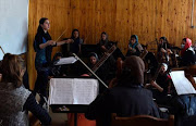 In this January 8, 2017 photo, Negina Khpalwak, the first female orchestra conductor in Afghanistan, is seen during a rehearsal at the National Institute of Music in Kabul.