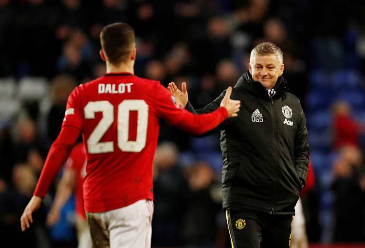 Manchester United manager Ole Gunnar Solskjaer celebrates after the match with Diogo Dalot