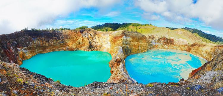 A pair of volcanic lakes in the Kelimutu National Park on Flores, one of the islands in the East Nusa Tenggara region of Indonesia.