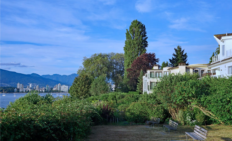 A waterfront park in the West Point Grey area of Vancouver, with a view of the city skyline in the distance.
