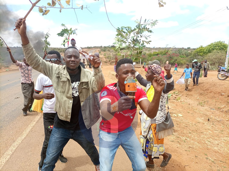 Supporters of Muema Nduku who blocked Kyuso-Mwingi road demonstrating next to a bonfire at Kamuwongo bridge in Kitui county on Monday, August 15,2022.