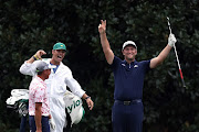 Jon Rahm of Spain celebrates with his caddie Adam Hayes and Rickie Fowler of the United States after skipping in for a hole in one on the 16th during a practice round prior to the Masters at Augusta National Golf Club on November 10, 2020 in Augusta, Georgia. 