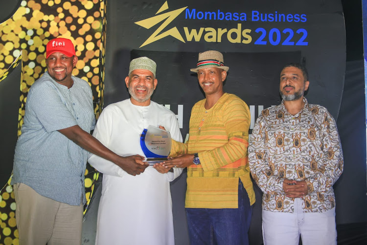 Mombasa Governor Abdulswamad Nassir hands over an award to veteran hotelier Mohammed Hersi during the ninth Mombasa Business Award.