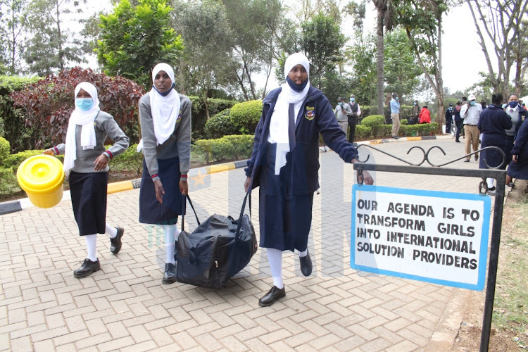 Form one students Madina Tura, Sumeya Mohammed and Madina Tura after reporting at St George's Girls' Secondary School, Nairobi on August 2, 2021.