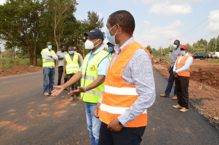 MPs Joseph Nduati (Gatanga) and Patrick Wainaina (Thika) with Kura officials inspect the Sh1.8 billion Del Monte BAT bypass in Thika on Tuesday.